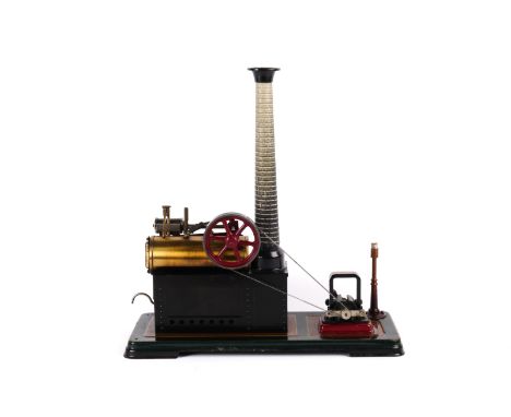 A Bing horizontal single cylinder (overtype) stationary steam engine. Mounted on a dark green and brown yellow lined metal ba