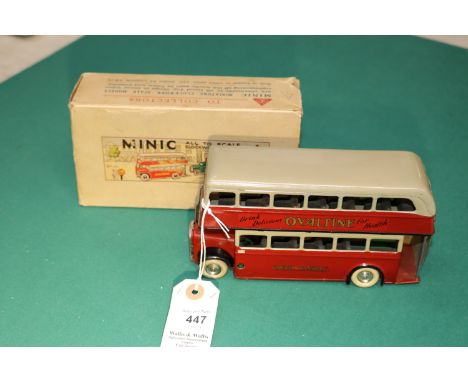 A scarce early issue Tri-ang Minic clockwork powered double decker bus 60M. An example in maroon and fawn London Transport li