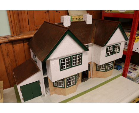 An impressively large Tri-ang No.92 dolls house. Made in the style of a 1930's suburban detached dwelling. Twin gabled with t