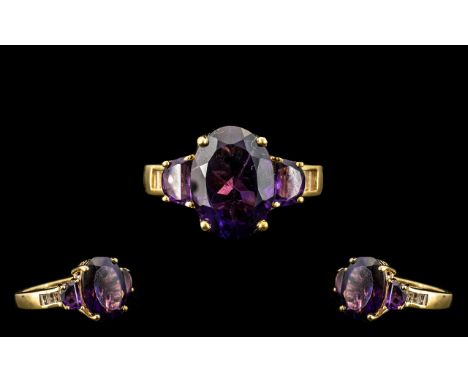 Deep Purple Amethyst Oval and D Cut Ring, a 5ct oval cut, rich, deep purple amethyst, set with a .5ct D cut amethyst to each 