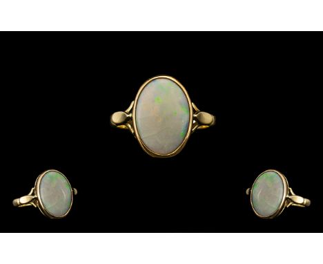 Ladies Attractive 9ct Gold Single Stone Opal Set Ring.  Full hallmark for Birmingham 1966.  Pale opal of oval shape, with ora