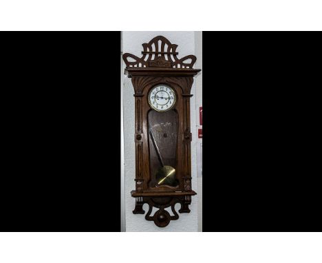 Austrian Oak Cased Double Brass Weighted Vienna Wall Clock. The case inspired by the art nouveau style at this period, with a