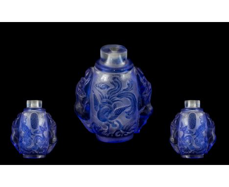 Chinese Blue Cameo Glass Snuff Bottle, carved to the body with dragons and phoenix birds, with mythical animals to the side, 