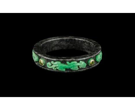 Oriental Bangle of Unusual Form, green stone chilogs applied to the grey marble body of the bangle, interspaced with coloured