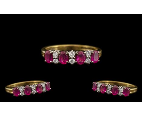 18ct Gold Attractive Ruby &amp; Diamond Set Dress Ring.  The four rubies with six diamond spacers.  The rubies and diamonds o