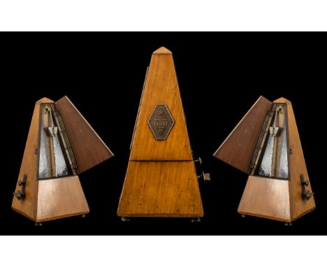 Wooden Metronome by Paquet of France.  This is a vintage or antique metronome made by Maelzel Paquet in France.   A gold plaq