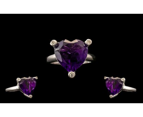 Amethyst Heart Shape and Feature Setting Ring, a 9ct heart cut, deep purple amethyst held in an openwork gallery by three ext