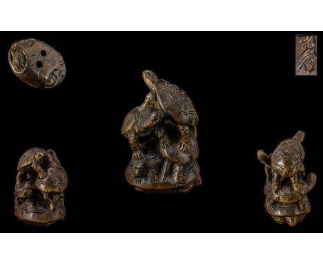 An Oriental Boxwood Netsuke in the form of a group of turtles.  Signed to base.  Please see accompanying images.