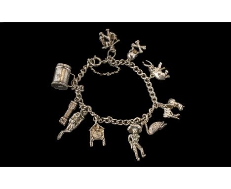 Silver Charm Bracelet loaded with some interesting charms, skull and crossbones, deep sea diver etc., all fully hallmarked fo