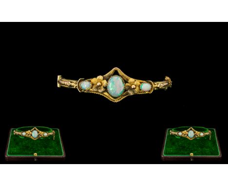 Edwardian Period Ladies Attractive Opal Set 9ct Gold Ornate Hinged Bangle, full hallmark for 9ct, the central oval shaped opa