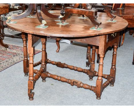 An 18th Century Oak Gate Leg Dining Table, on turned and block supports, 145cm by 125cm by 75cm