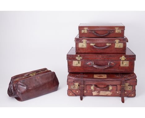 Six Vintage leather suitcases some with travel labels, one with maker label 'Kelvin' brand.