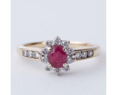 A 9ct yellow gold cluster ring set with approx. 0.30 carat oval cut ruby &amp; approx. 0.20 carats of round brilliant cut dia