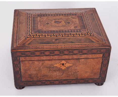 A Victorian walnut and parquetry inlaid sewing box the lid with a pictorial scene with a fitted tray of sewing thread and con