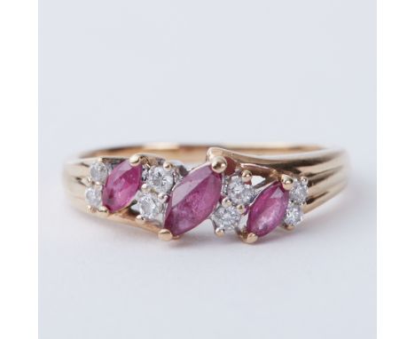 A 9ct yellow gold ring set with approx. 0.28 carats of marquise cut rubies and approx. 0.16 carats of round brilliant cut dia