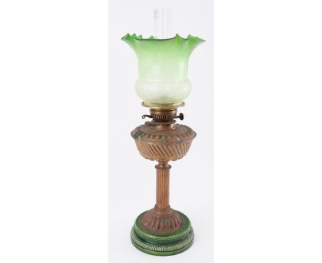 A Victorian brass oil lamp with green etched glass shade.