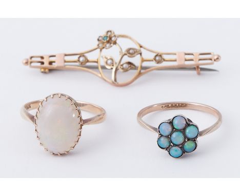 A mixed lot to include a 9ct yellow gold ring set with an oval cabochon cut white opal, 2.47gm, a 9ct yellow gold ring set wi