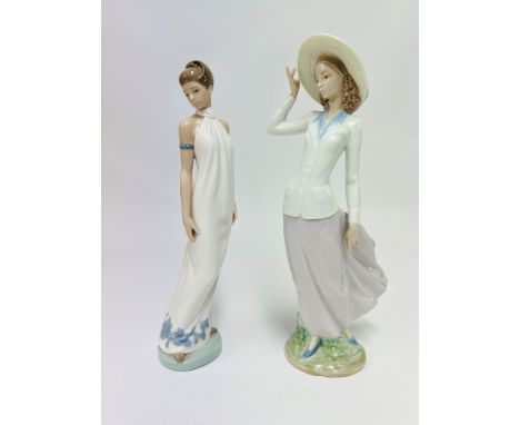 One Lladro lady figurine and a Nao lady figurine (damaged).