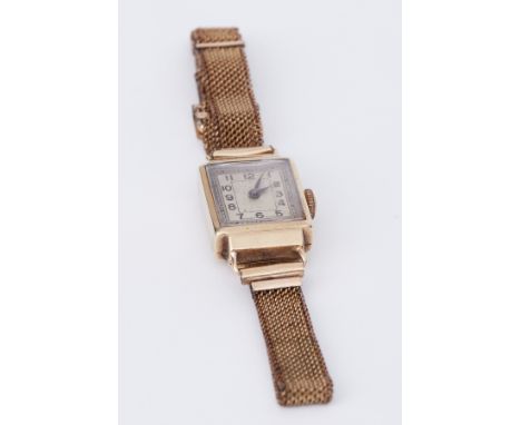 A vintage ladies mechanical wristwatch with mesh bracelet and gold case.