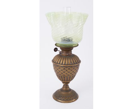 A small brass oil lamp with green opaline twist glass shade.