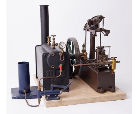 A Stuart steam engine with boiler and manual feed pump, 13" high with 12" base.