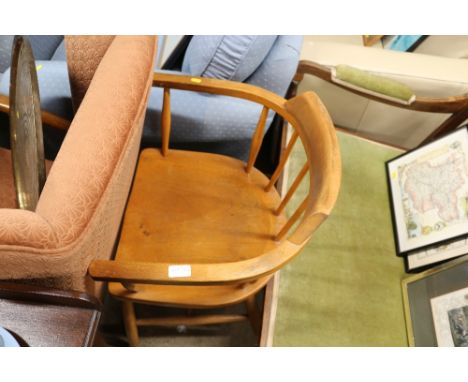 An Ercol style elm seated captain's chair