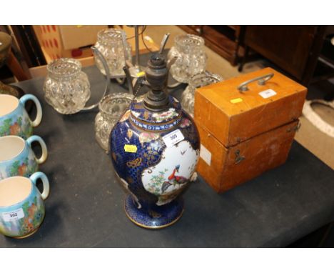 A Booths porcelain baluster table lamp, decorated with exotic birds, retailed by T Goode &amp; Co.