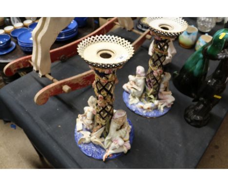 A pair of Royal Worcester comport decorated with musicians, dogs and trailing foliage, modelled by G Toft AF