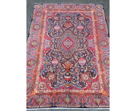 PERSIAN HAND KNOTTED WOOL CARPET, with a central lozenge of floral designs, surrounded by designs of vases of flowers, border