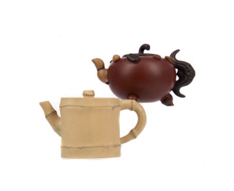 20TH CENTURY CHINESE YI XING TEA POT, decorated in relief with nuts to the squat circular body, with a stylised bat formed ha