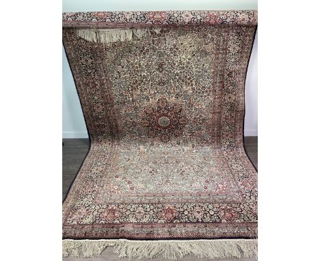 EASTERN PART SILK BORDERED CARPET, with a central styilsed floral motif, in elaborate surrounds of floral designs and multi b