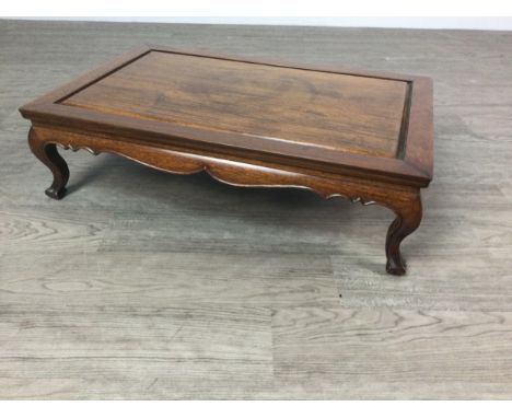 EARLY 20TH CENTURY CHINESE HARDWOOD LOW TABLE, the rectangular top over a curved apron and on cabriole legs with scroll feet,