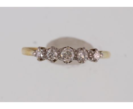 An 18ct H/M five-stone diamond ring, the graduated round brilliant cut diamonds approx 0.30ct, approx weight 1.6gms, size L