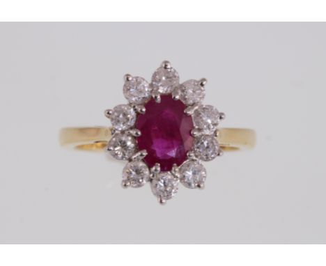 A modern 18ct H/M ruby and diamond cluster ring, approx total diamond weight 1.00ct, approx 5.6gms, size P