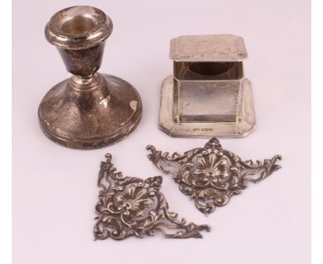 A single silver dwarf candlestick, a silver capstan inkwell & a pair of H/M silver embossed corner decorations