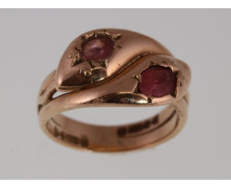 A 9ct rose gold double snake ring set with two pink stones, H/M Chester 1919, approx 8.5gms, size R