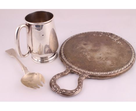 A silver hand mirror H/M Chester 1905, a christening mug H/M Birmingham 1962 & a Victorian pickle fork H/M London 1869 (3)