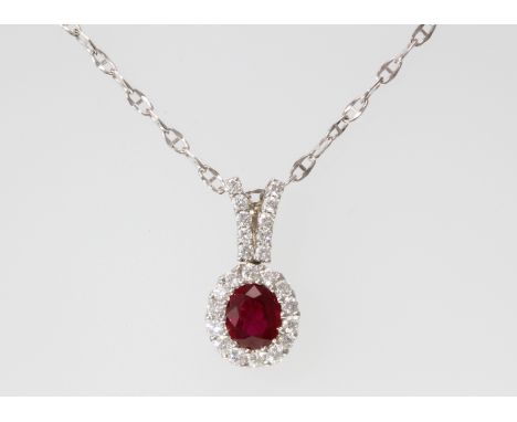 An 18ct H/M ruby and diamond cluster set pendant and chain