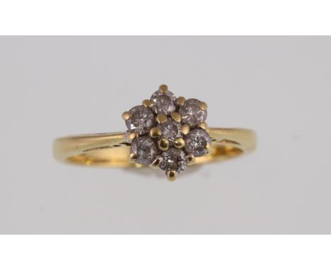 An 18ct yellow gold H/M diamond daisy cluster ring, the seven brilliant cut diamonds approx total weight 0.50ct, approx weigh