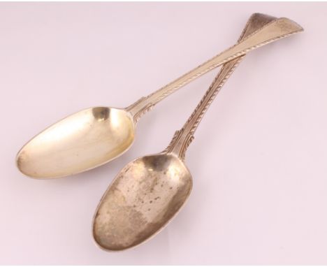 A pair of 18th century silver H/M table spoons with feather-edge decoration, approx weight 123gms