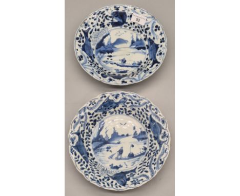A Pair of 19th century Chinese Kangxi blue and white Shallow bowls with fishing scenes and fish design borders. [22.5cm diame