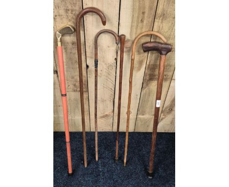 A collection of vintage walking canes; Golfing putter walking stick, Leather hide topped walking stick &amp; others 