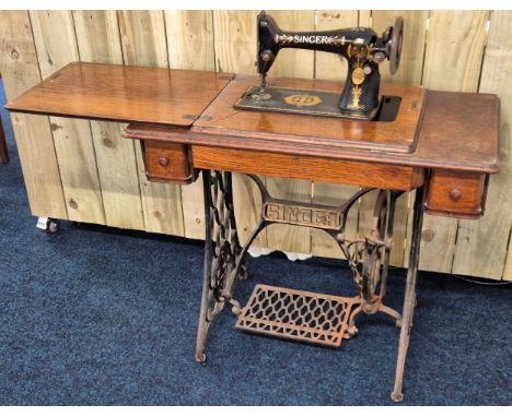 The singer manufacturer company cast iron based sewing machine with fitted pedal model no. F7637502.[77x92.5x46cm]