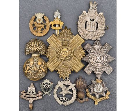 A Selection of various military cap badges; Gordon Highlanders 92nd cap badge, The Royal Highlanders Black Watch cap badge, W