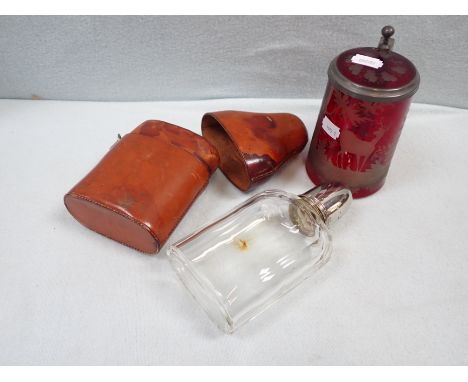 A CUT GLASS HIP FLASK with outer leather case and a Bohemian ruby glass stein (cracked) (2)