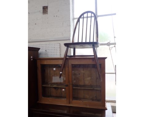 A VICTORIAN GLAZED PINE WALL CUPBOARD and an Ercol chair (2)