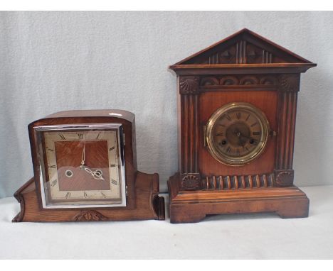 A WALNUT-CASED MANTEL CLOCK with pedimented top, and Junghans movement striking on a gong 37 cm high, and a 1930s oak-cased m
