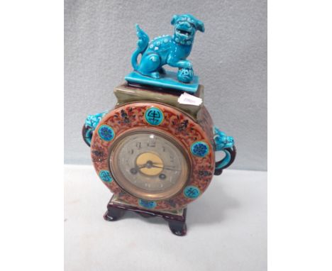 A VICTORIAN GLAZED CERAMIC MANTEL CLOCK in the Chinese style, decorated with a foo dog (old glued damage to the case)