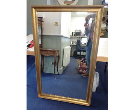 A LARGE GILT FRAMED WALL MIRROR 84cm high x 136cm wide