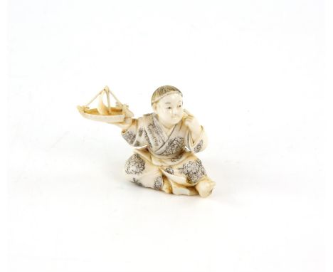 A Japanese Okimono , Meiji Period Circa 1880 Carved Ivory representing a boy man playing with a toy boat. 4.3 X 5.8 cm, Comes